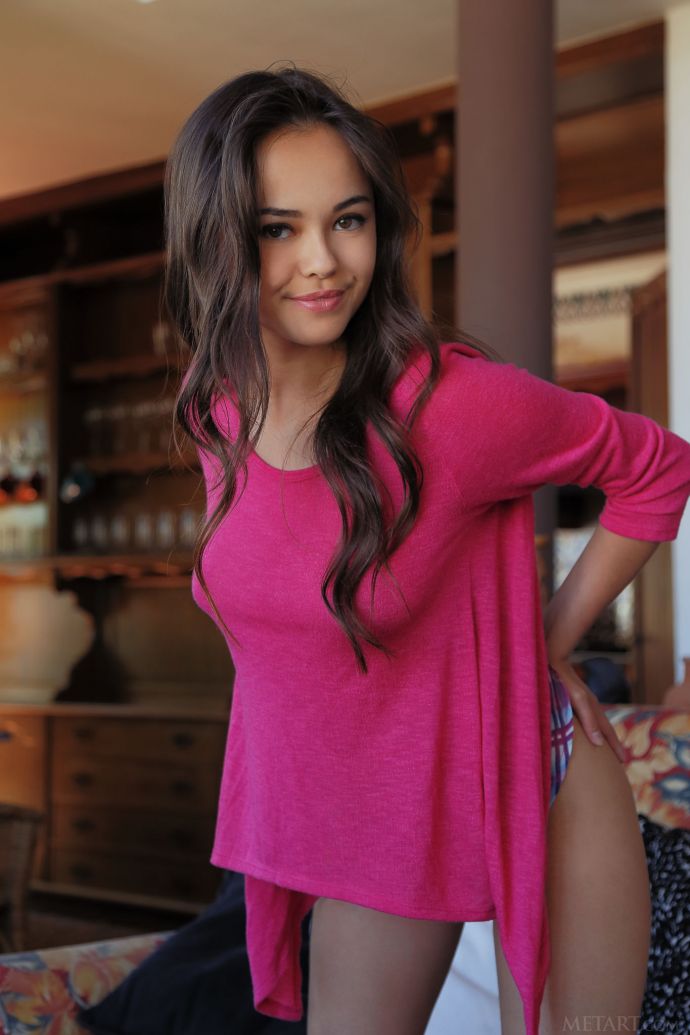 The cute girl getting naked on the sofa